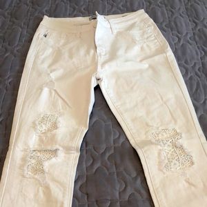 Distressed jeans with crochet detail.